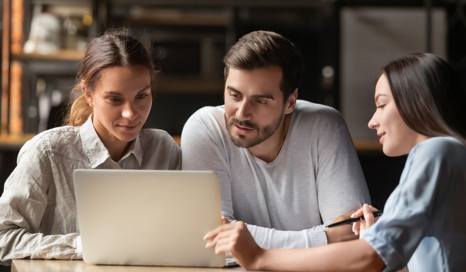 A realtor discussing a real estate email marketing campaign with her clients