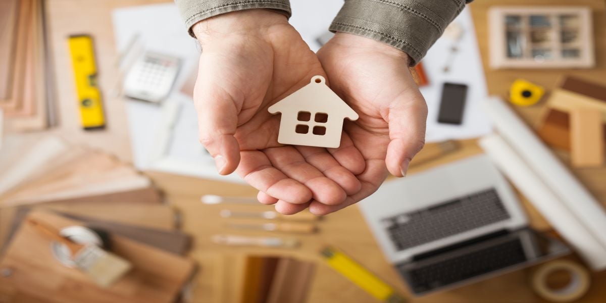 A homeowner holding a home keychain in their hands in anticipation of selling their home