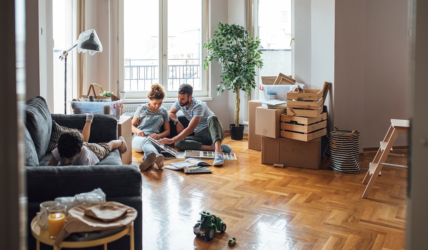 family moving sitting with boxes in new home